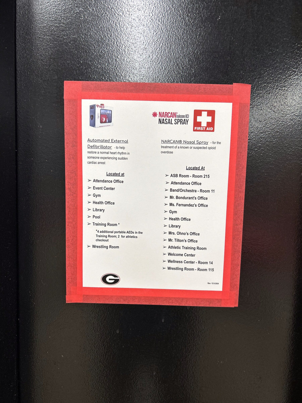 Flyer framed with red Mascot Tape border on a school door — tape frame keeps posters up