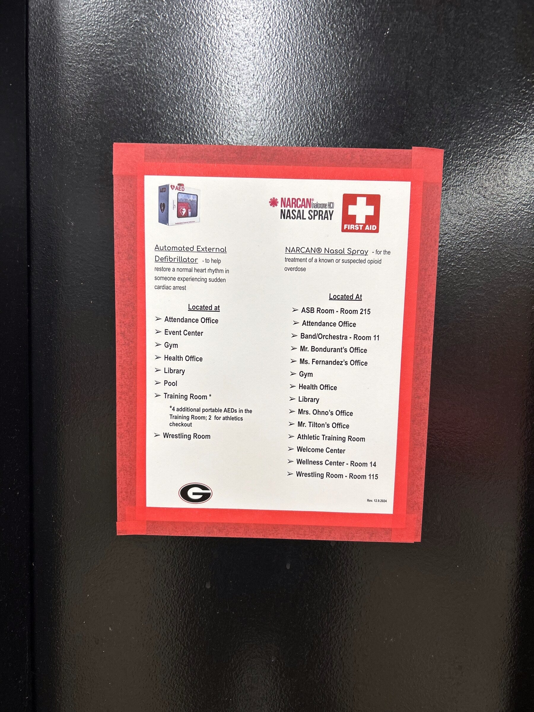Flyer framed with red Mascot Tape border on a school door — tape frame keeps posters up